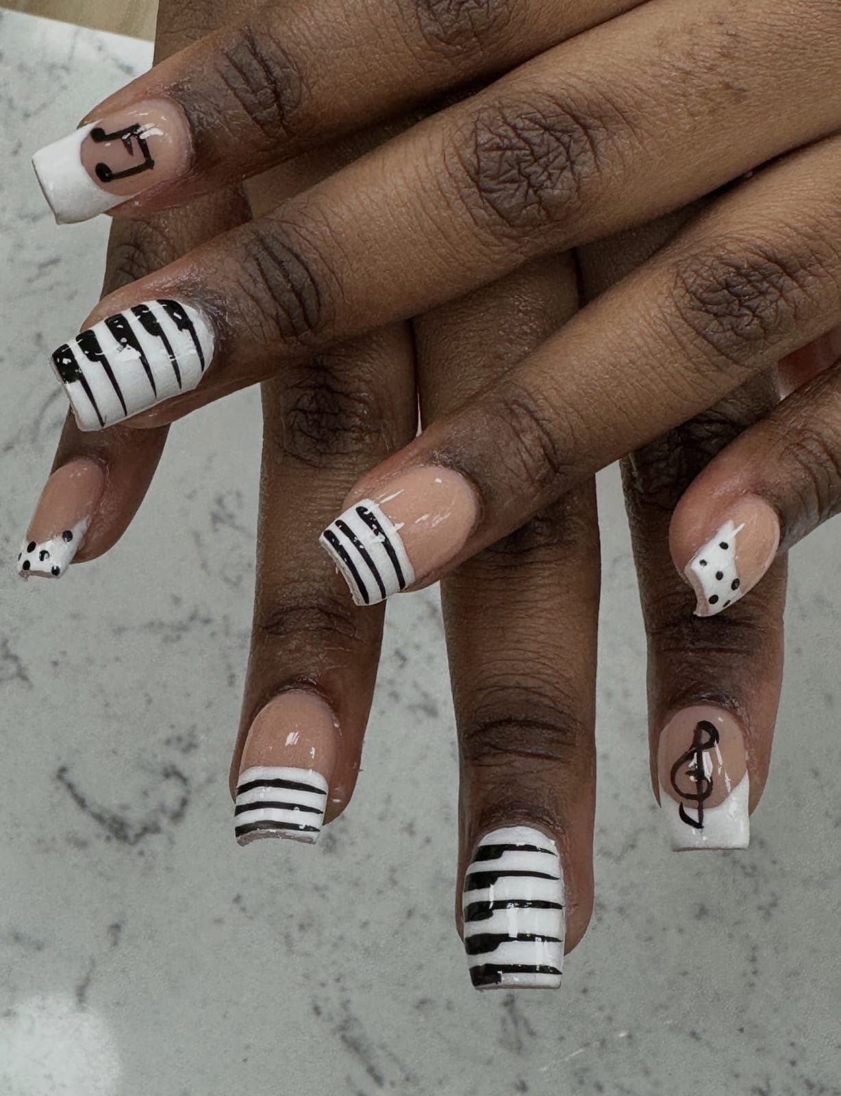 Black and white striped nails with music notes