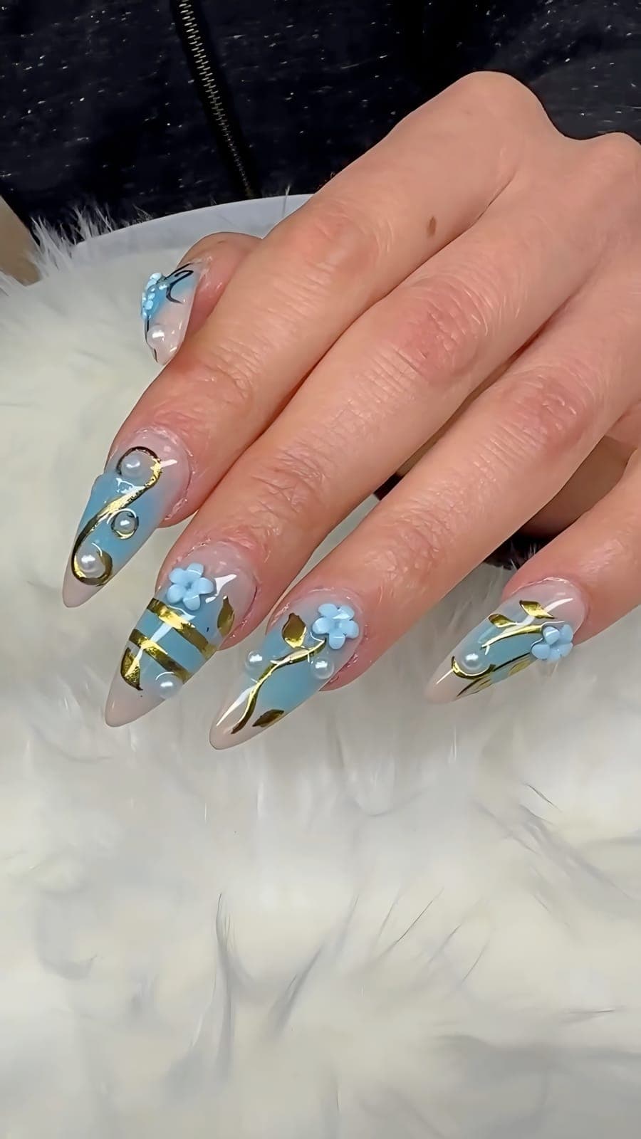 Almond nails with blue flowers and gold detail