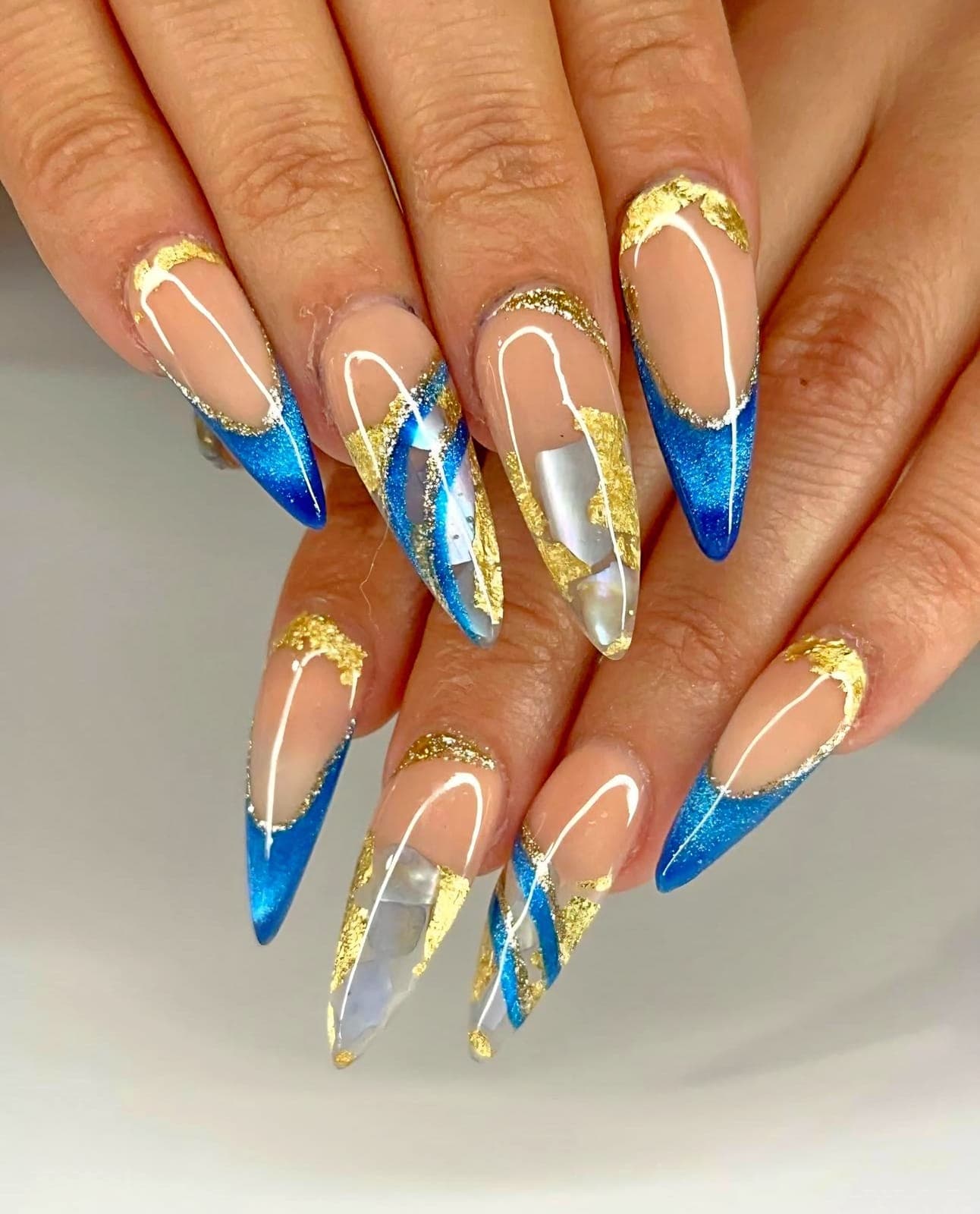 Blue and gold chrome French stiletto nails