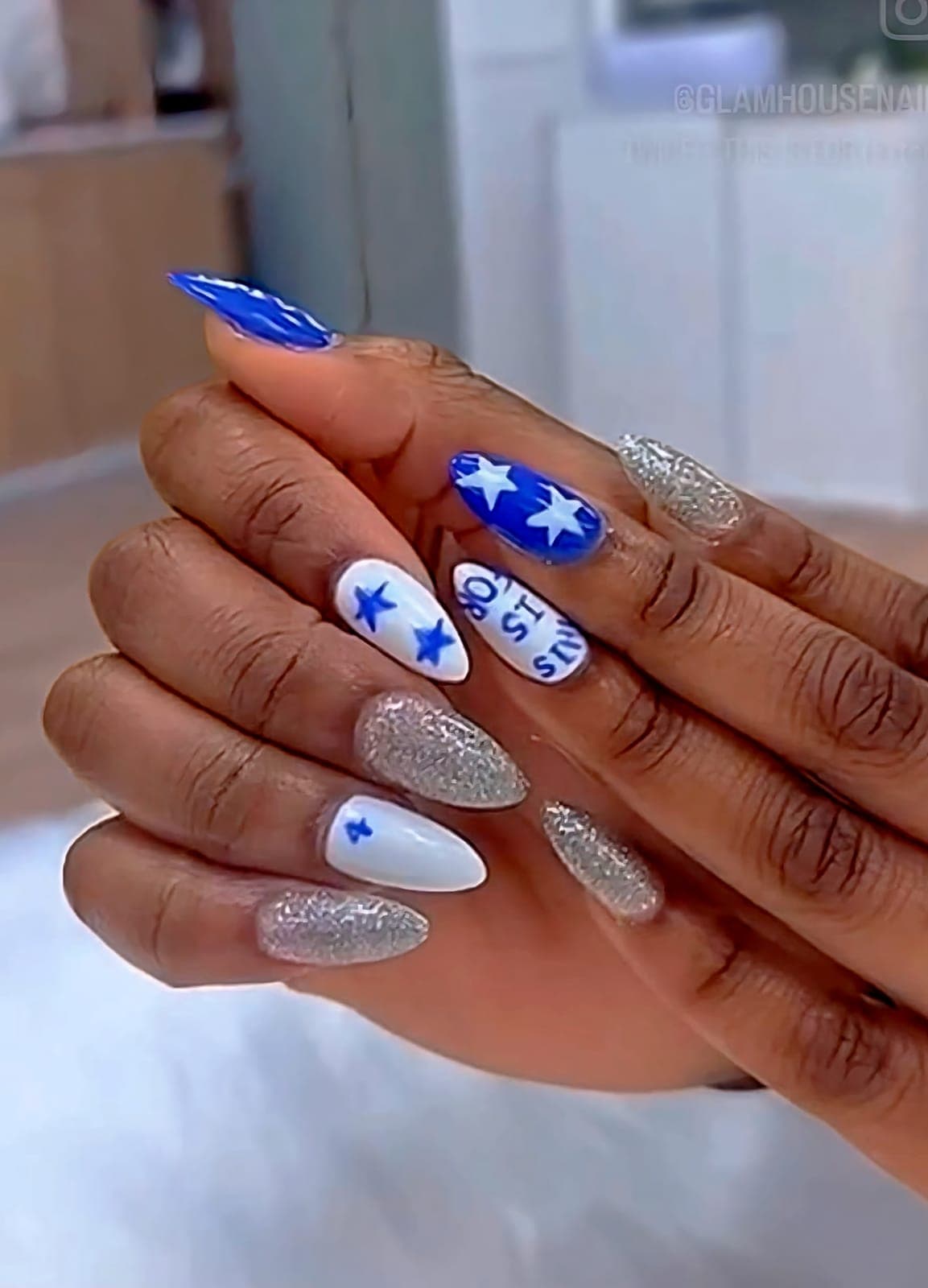 Blue and white star nails with silver glitter
