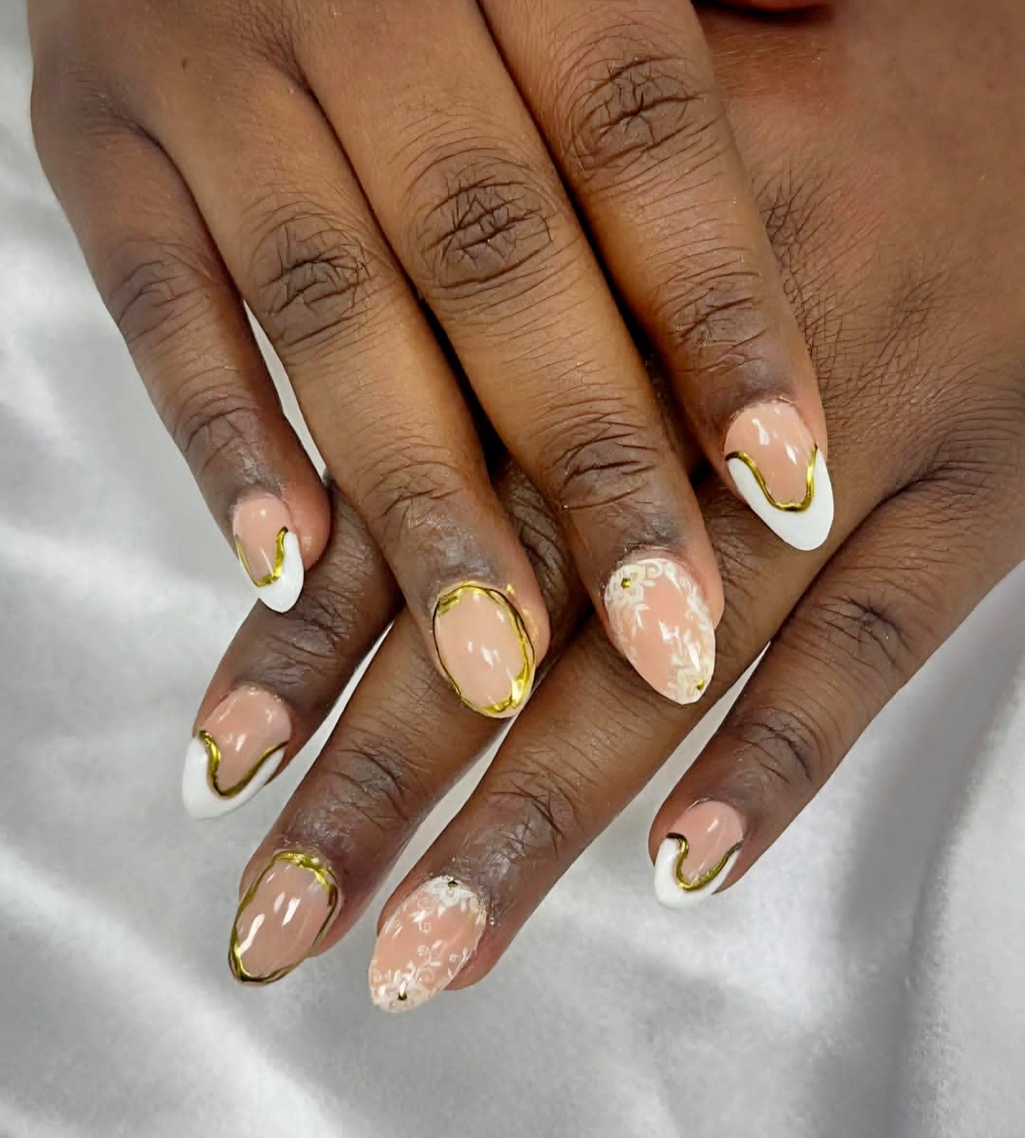 Nude nails with gold chrome and white outlines