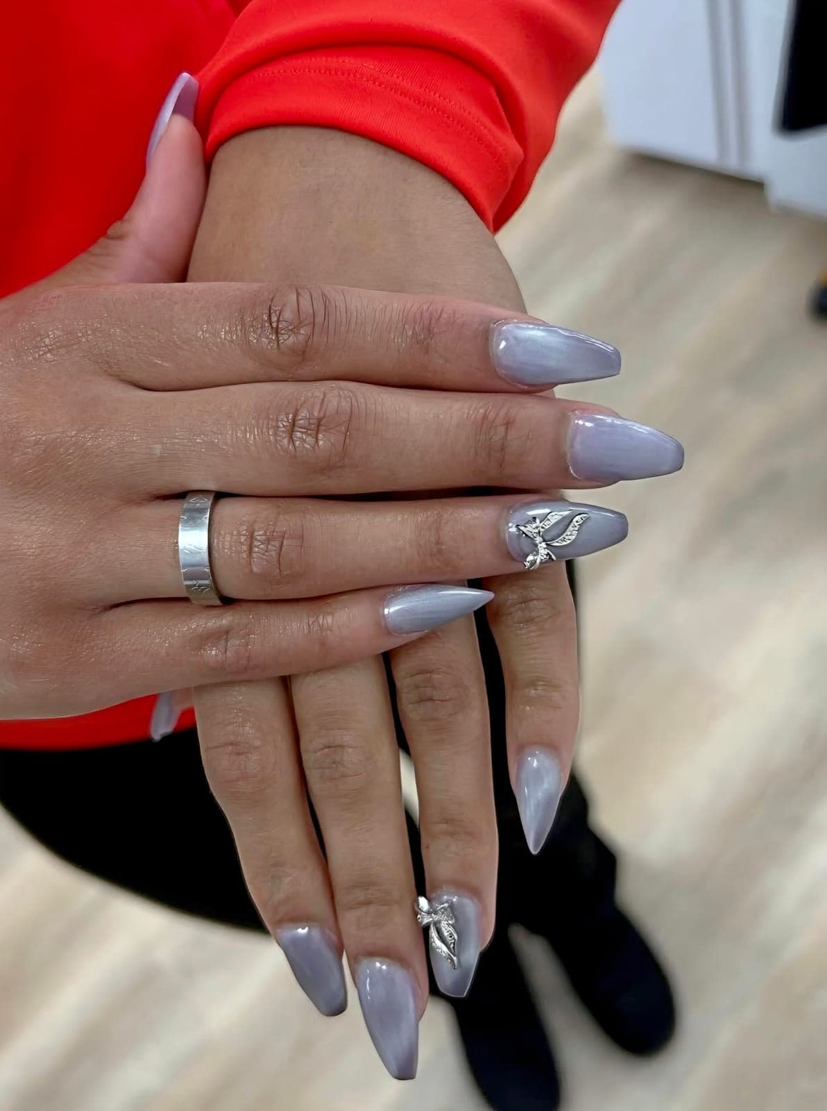 Grey almond nails with a chrome accent