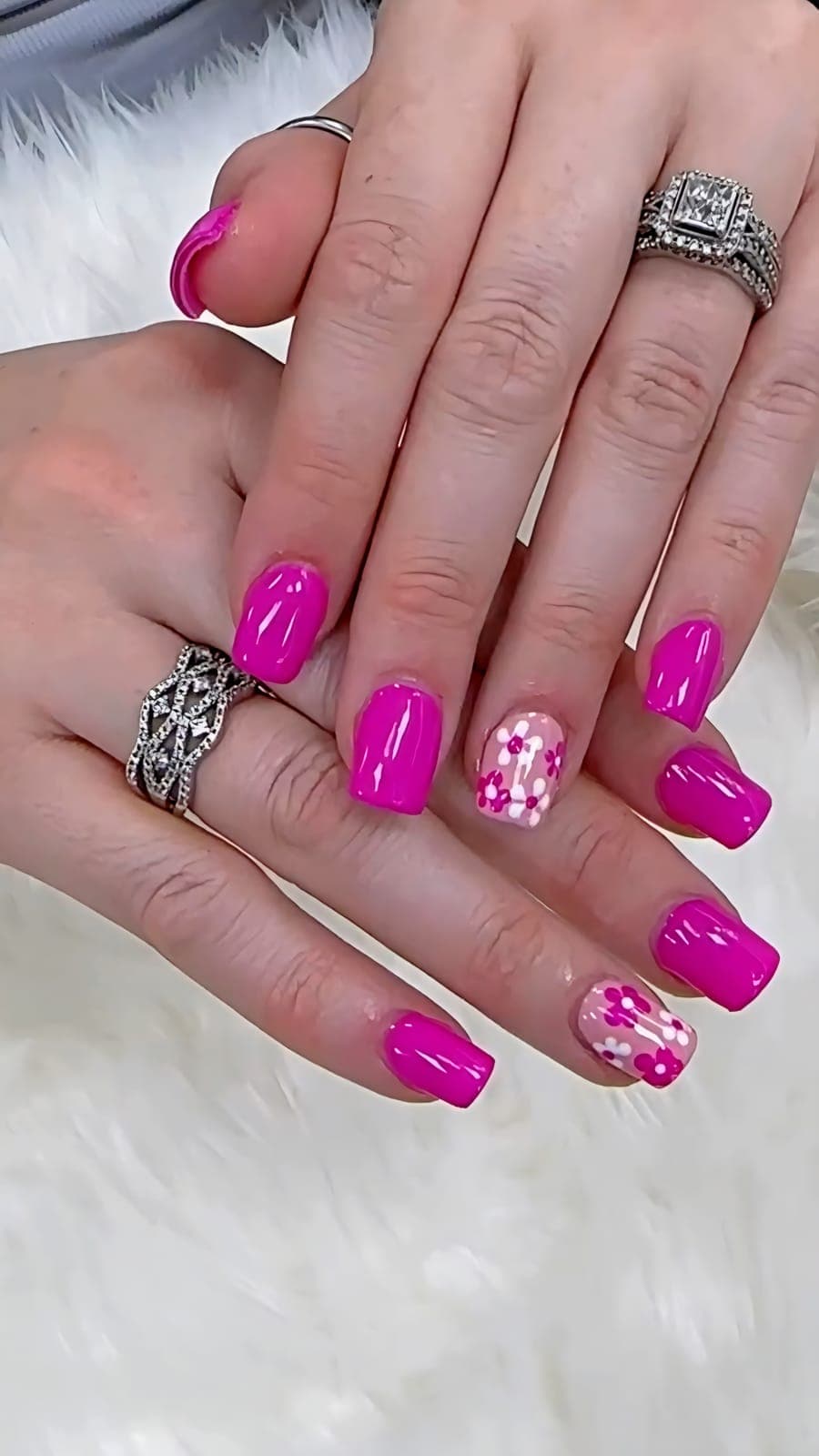 Hot pink nails with flower accents