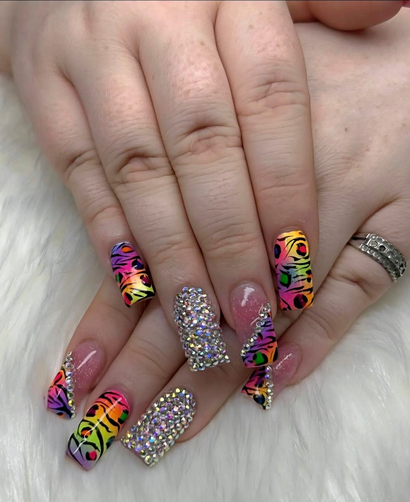 Neon animal print nails with crystal accents