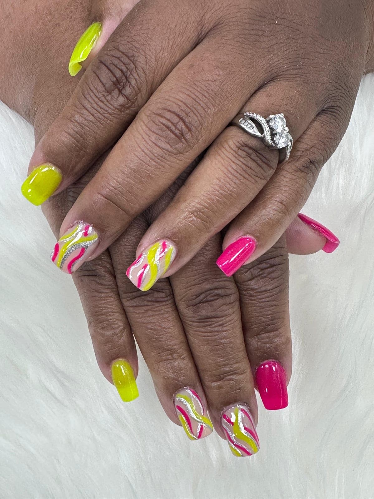 Neon pink and yellow nails with swirls
