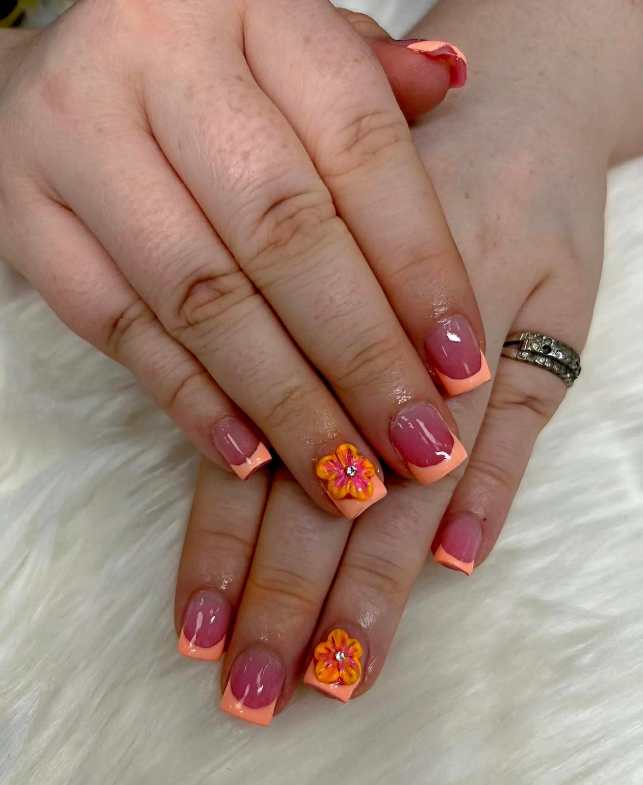 Short orange French nails with flowers