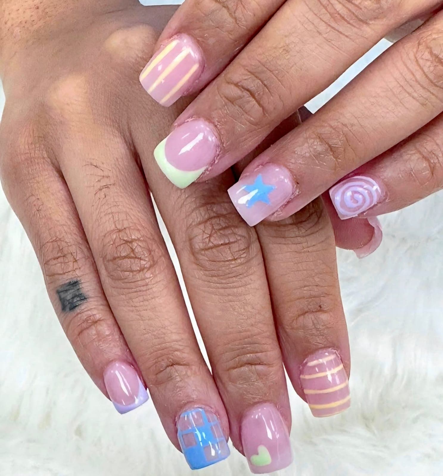 Short pastel nails, a different design on each