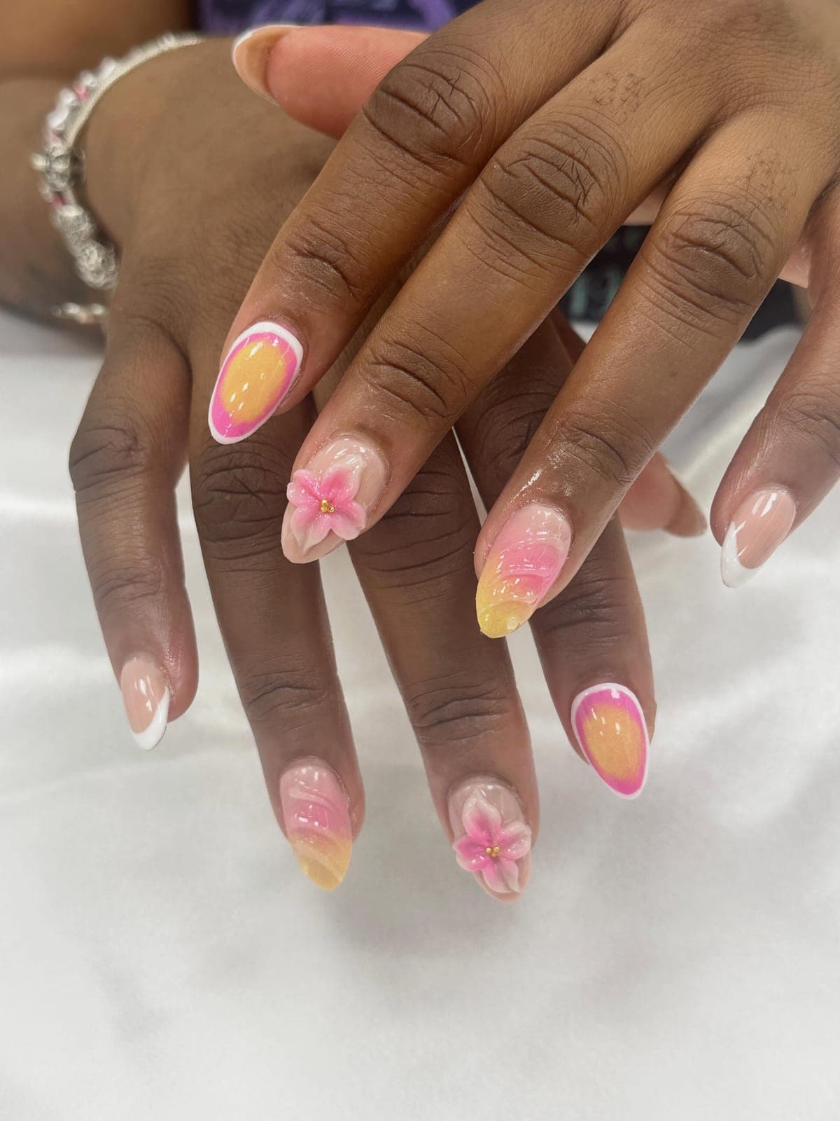 Almond nails with soft pink flowers and aura art