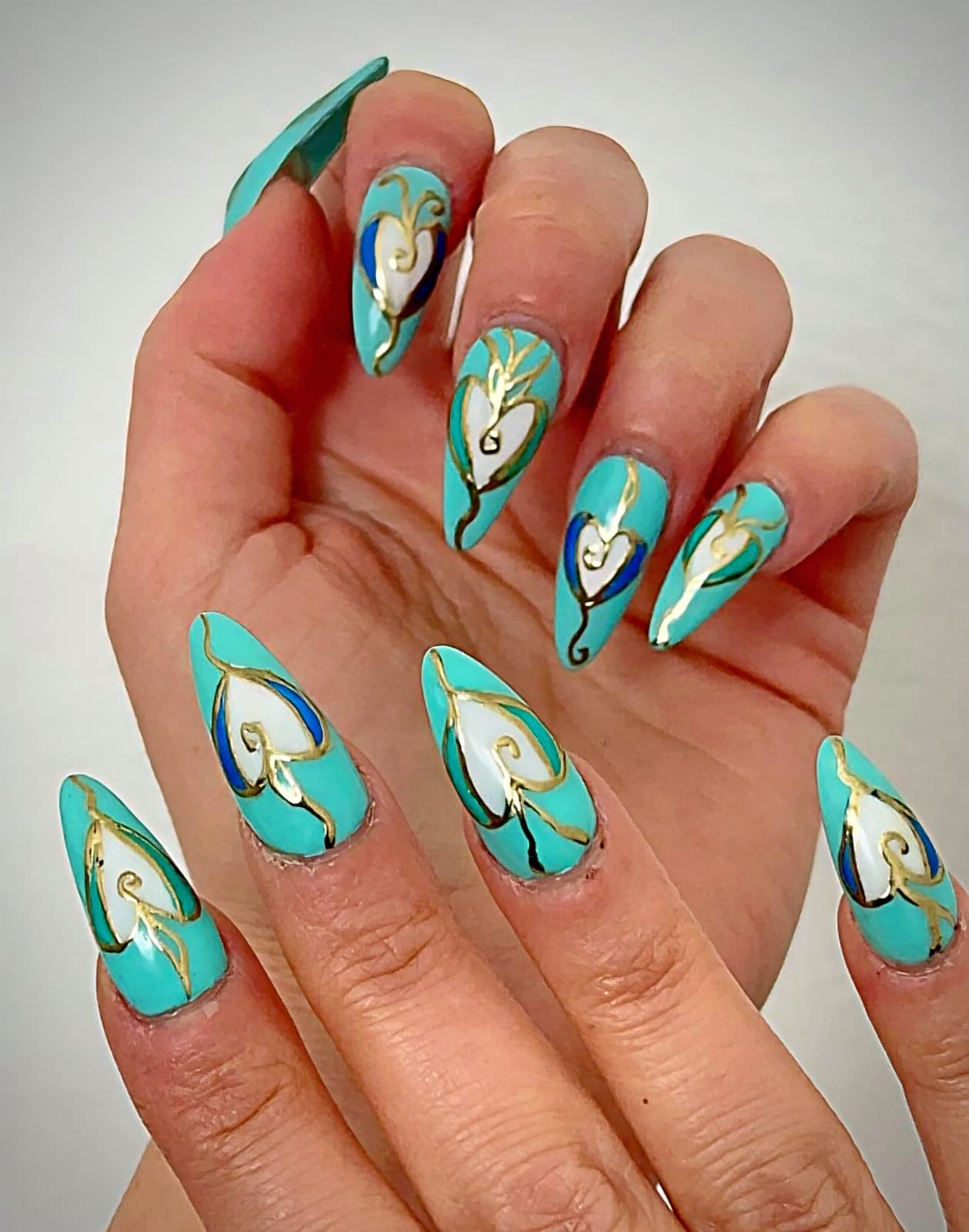 Teal almond nails with hand-painted art