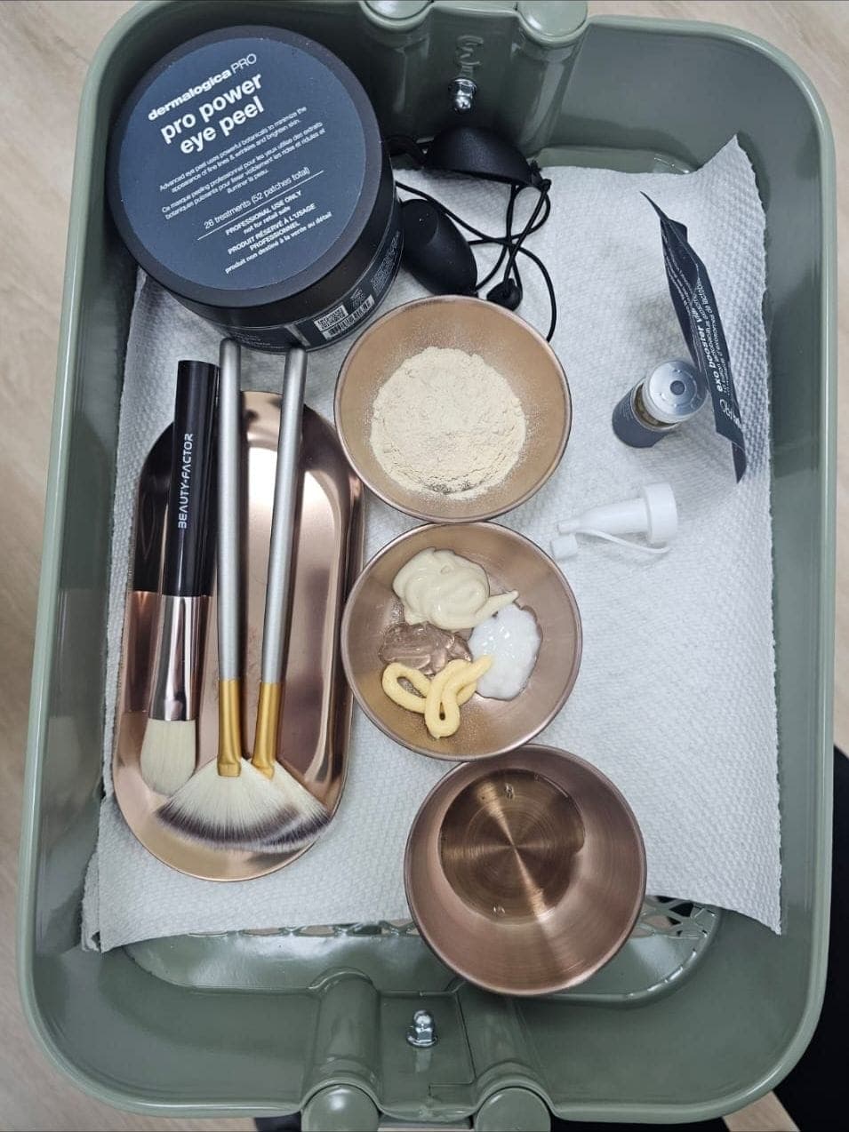 Rose gold bowls and brushes set out for a facial