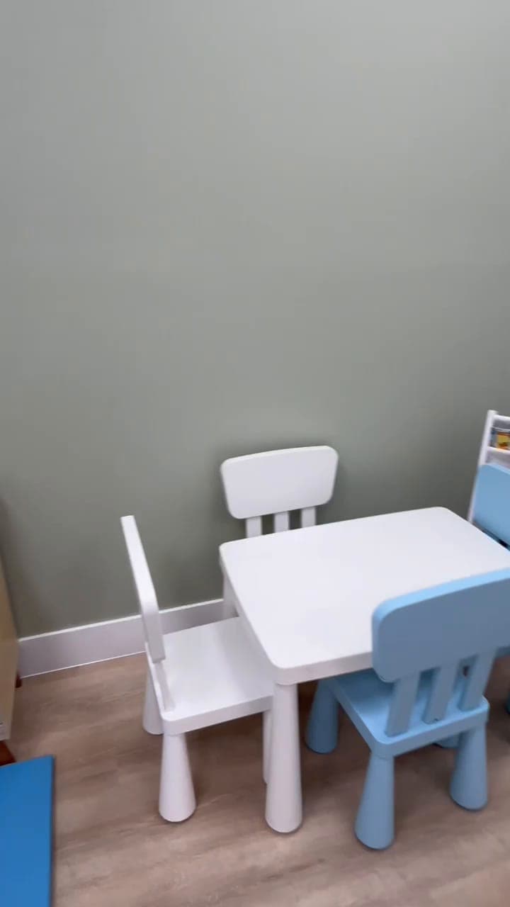 A kid-sized table and chairs in the kids room
