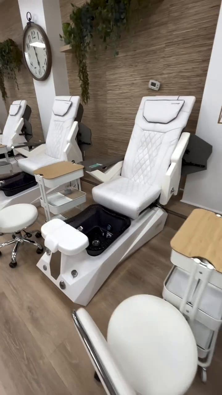 A white pedicure chair with the foot bath ready
