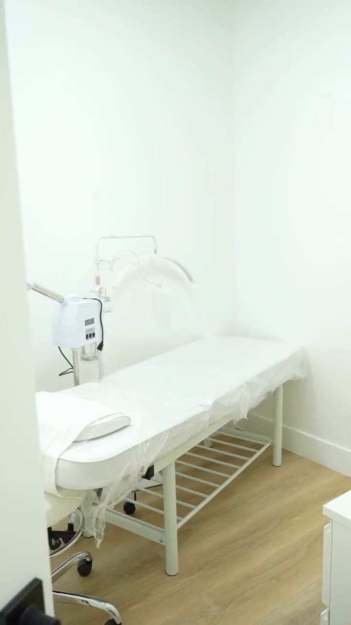 Private treatment room with a facial bed